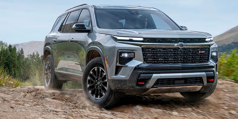 A gray suv driving off-road.