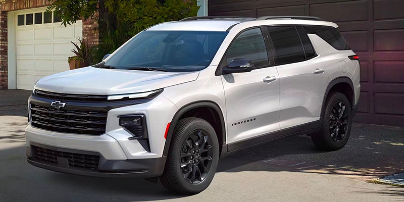 A white suv sitting parked.