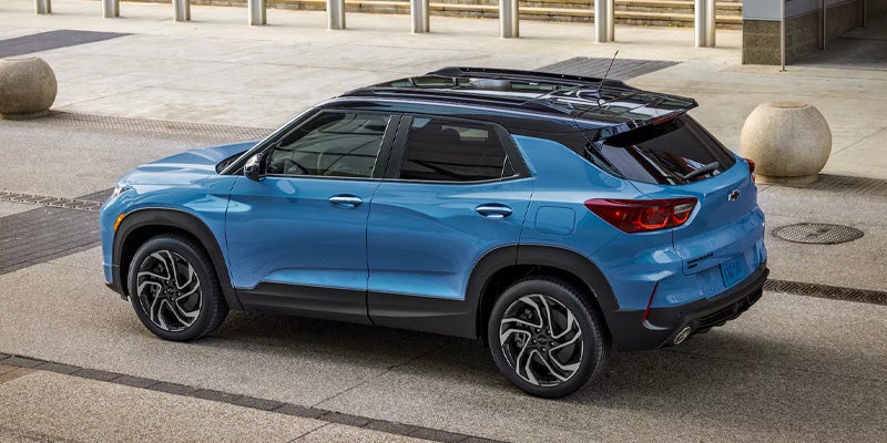 a blue 2026 chevy trailblazer parked next to a building