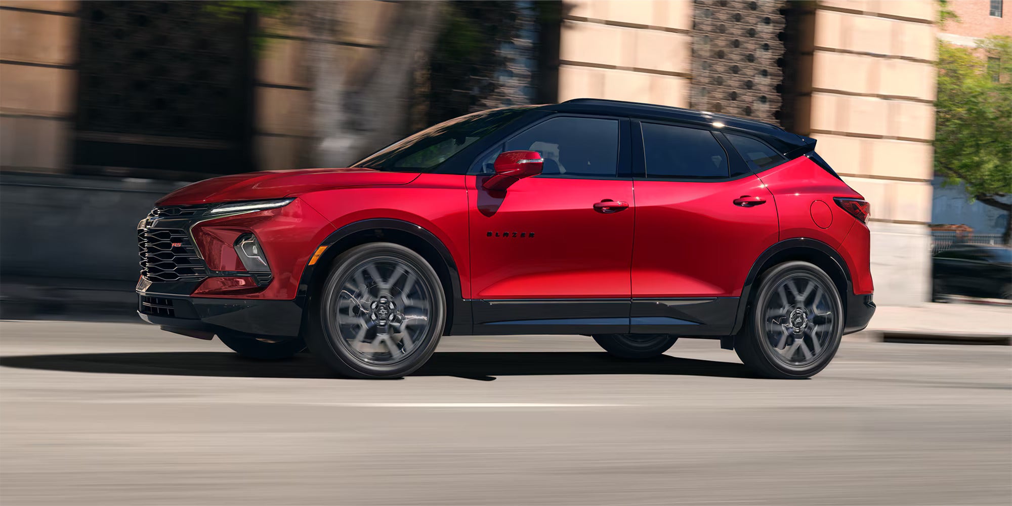 A red car driving on the road.