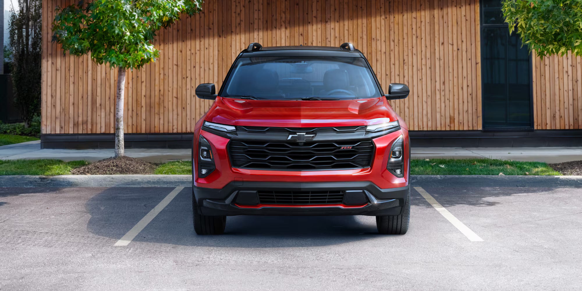 A red suv sitting parked in a parking spot.