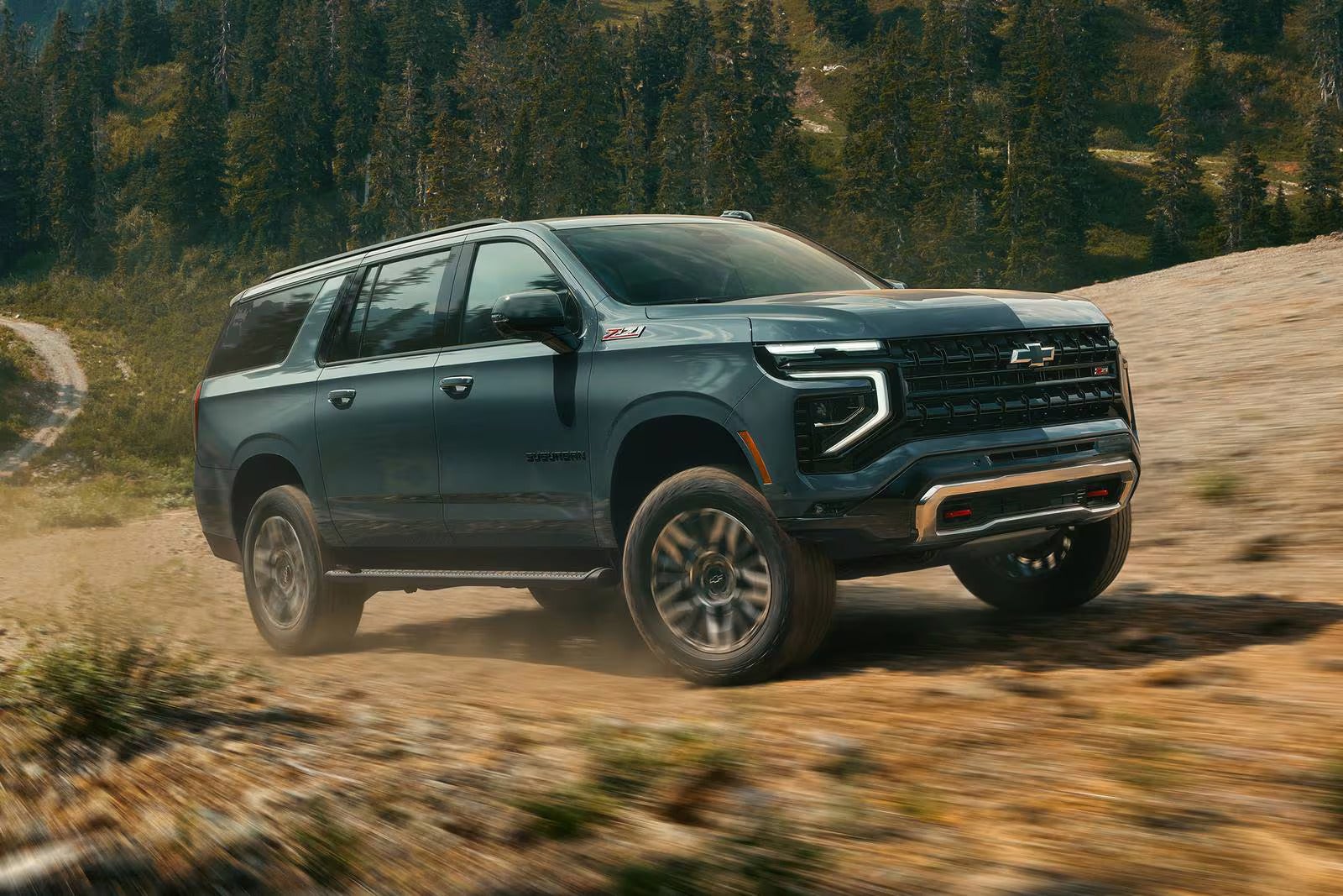 A blue suv driving off-road.