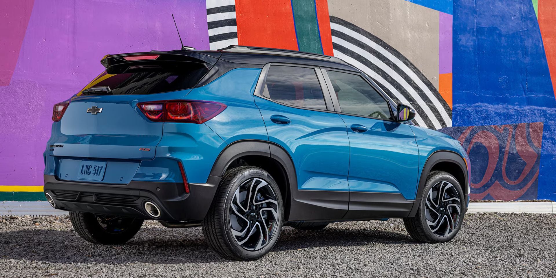 A blue car sitting parked.