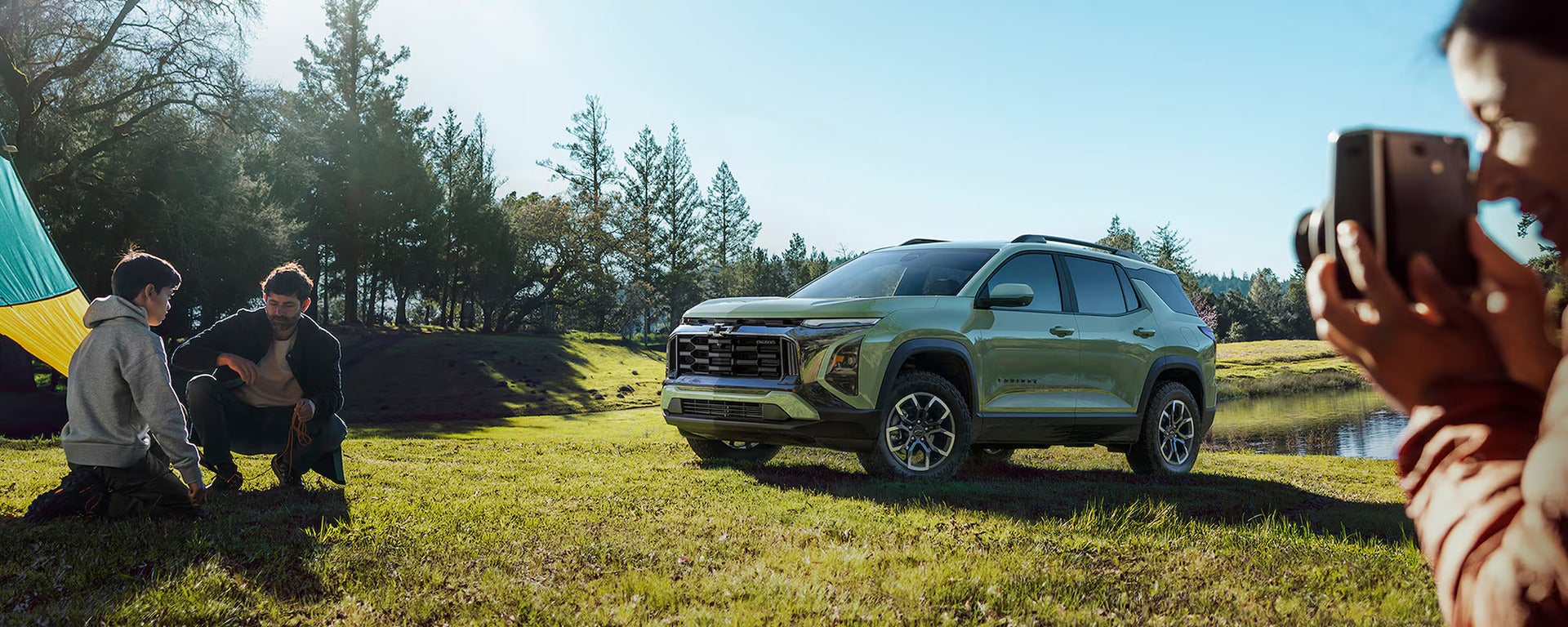 A green car sitting in a field.