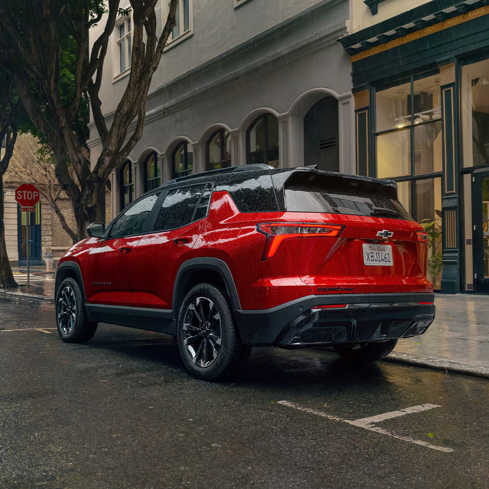 A red car parked on the side of the road.