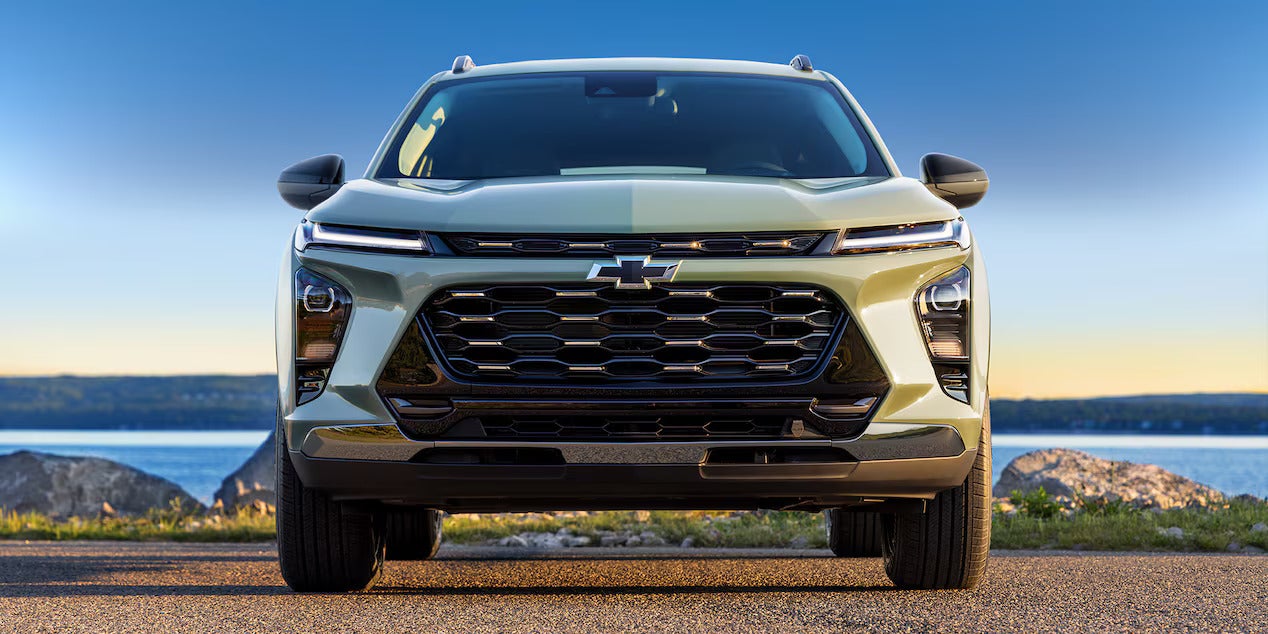 A green suv parked with the front facing.
