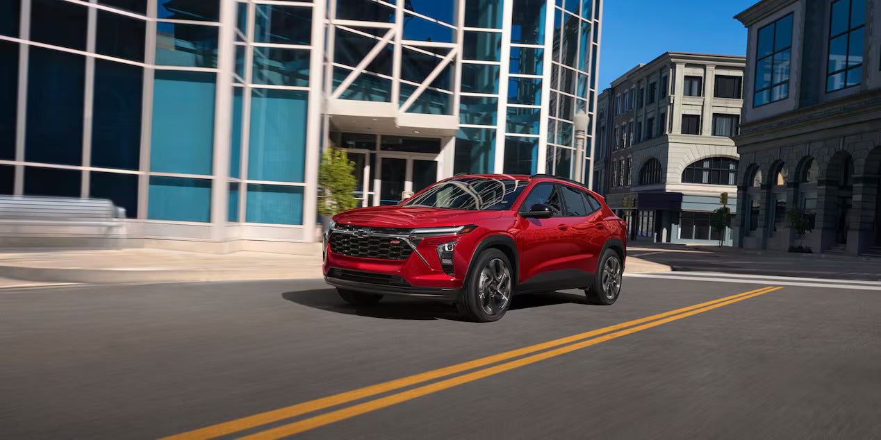 A red suv driving on the road.